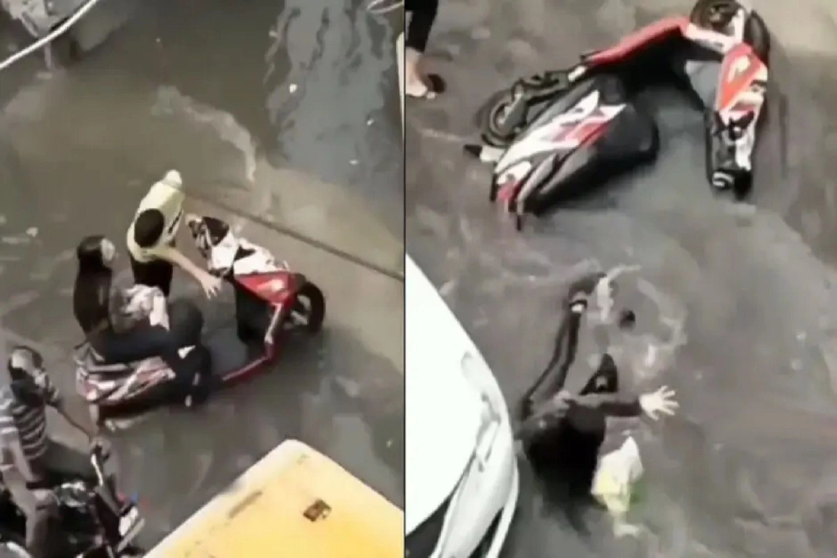 Girl Enjoys The Scotty Ride As Youth Drags Scooter On Waterlogged Road, See What Happens Next