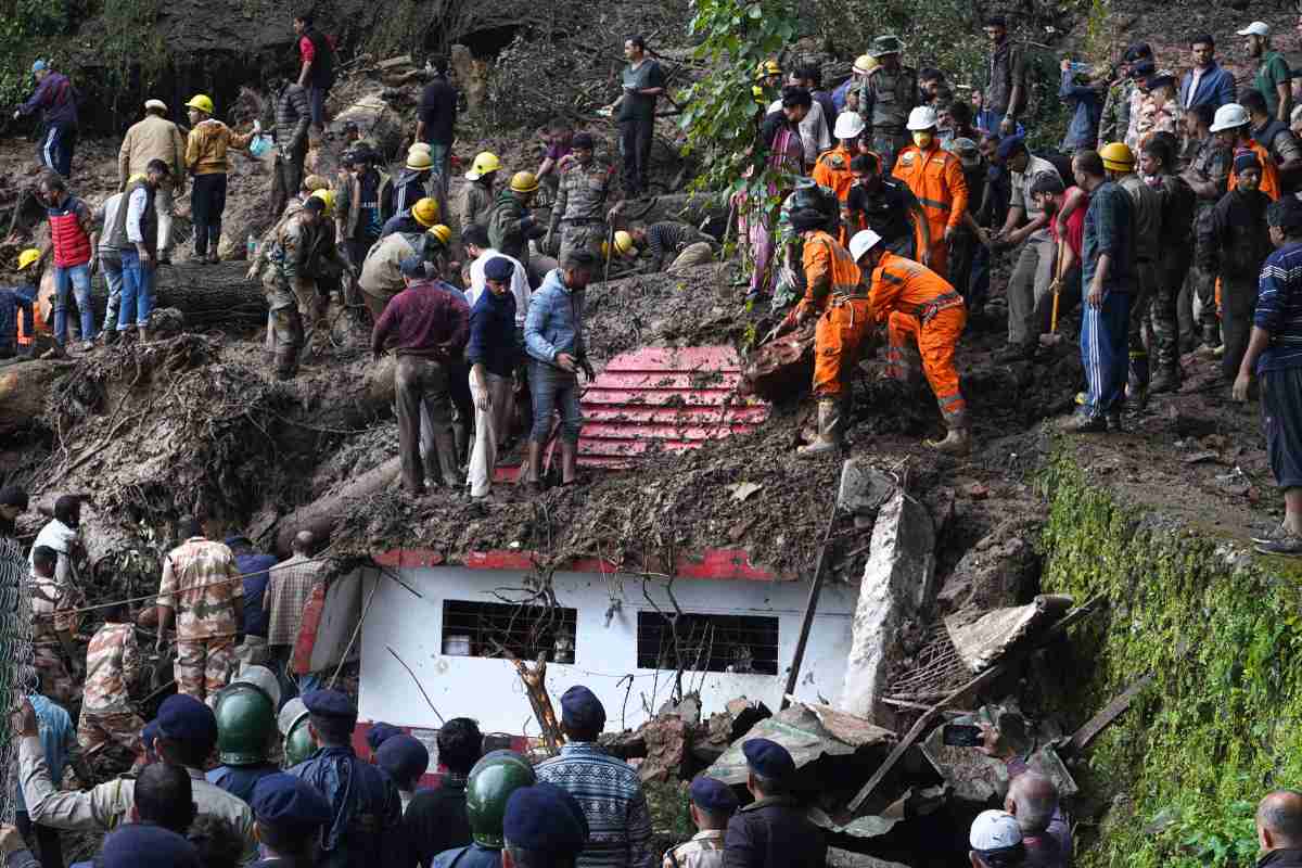 Rescue workers searching for victims of a landslide that struck a temple in Himachal Pradesh State, India.