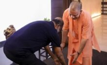 Rajnikant touches CM Yog's feet