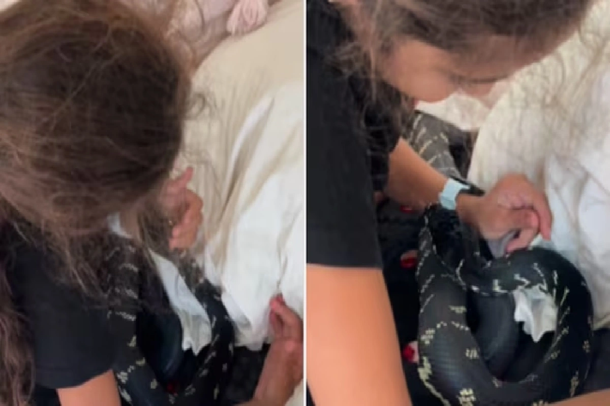 Internet calls it ‘dangerous’ after a girl sleeps with a snake and pets it
